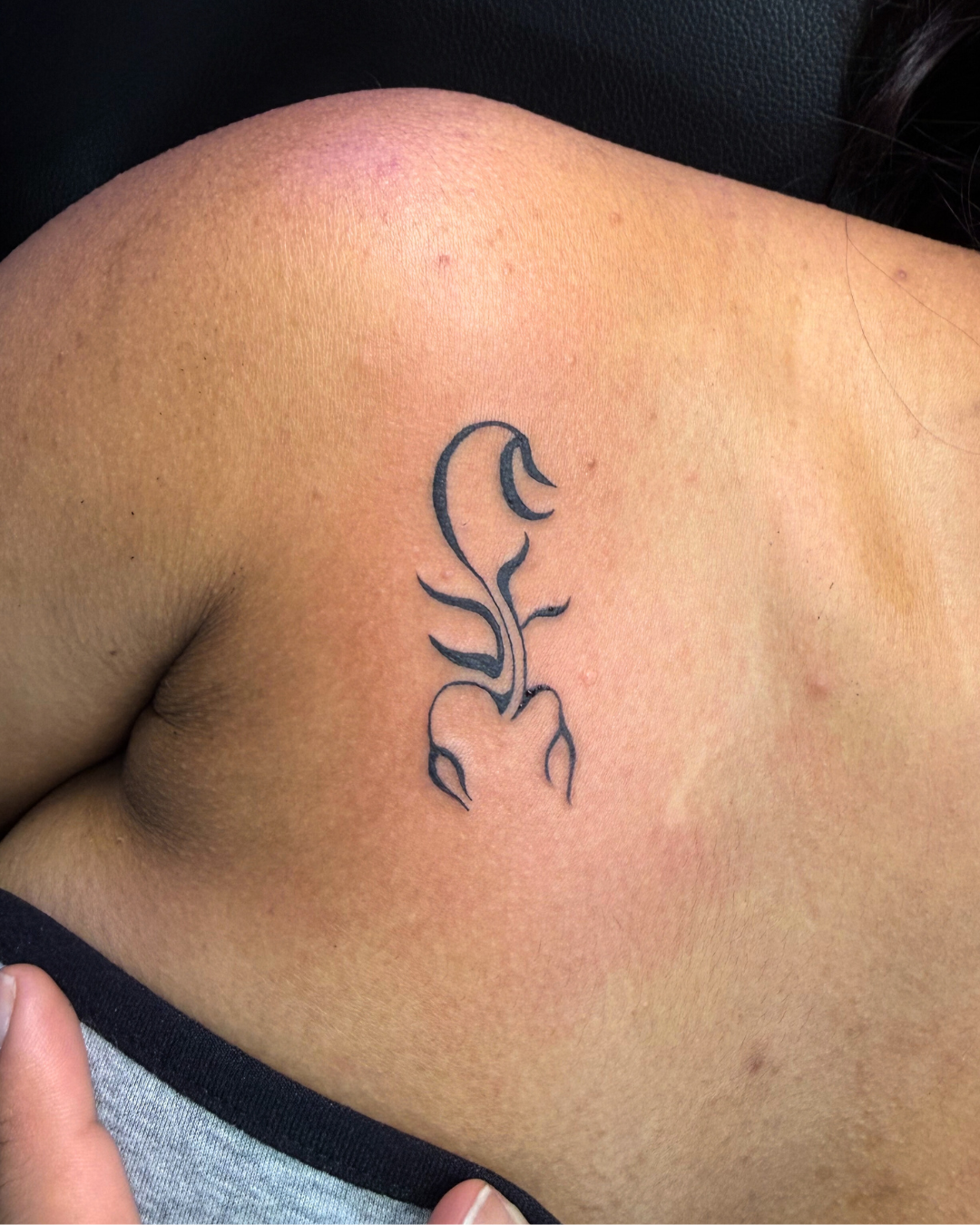 Black and grey geometric forearm tattoo with an eye, clock, and staircase leading upwards