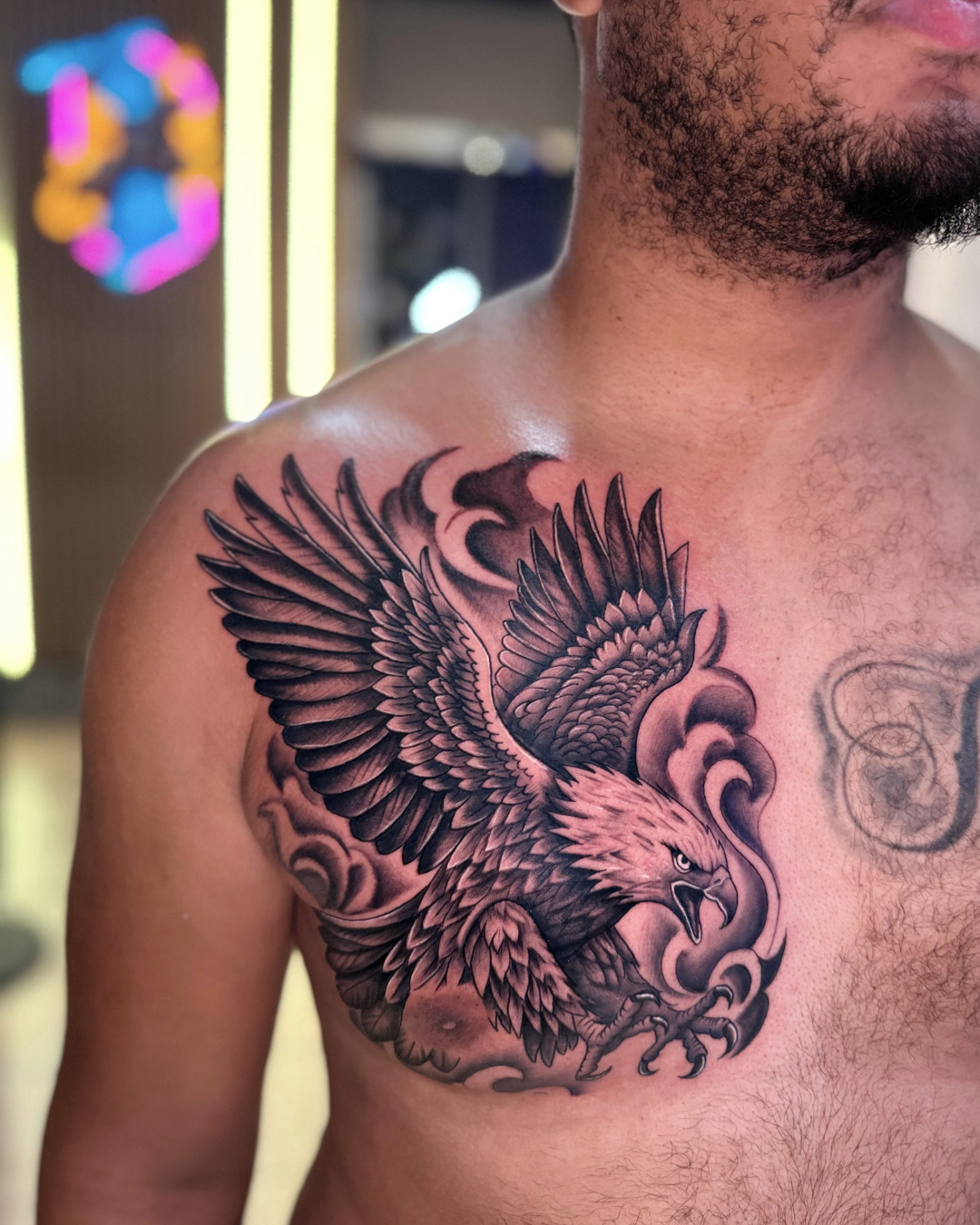 Large black and grey eagle tattoo on the chest