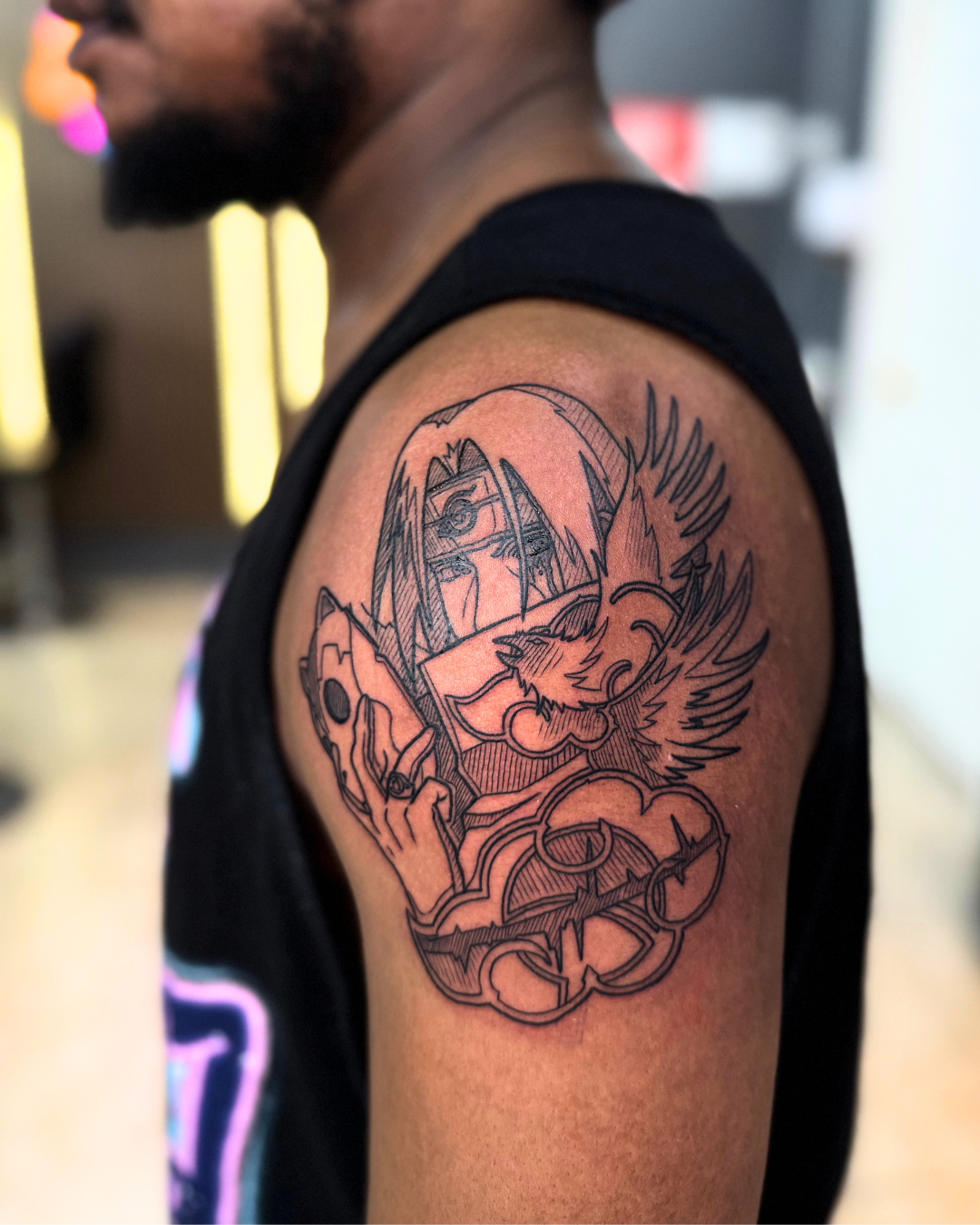 Black and grey Itachi Uchiha from Naruto with crows on the upper arm