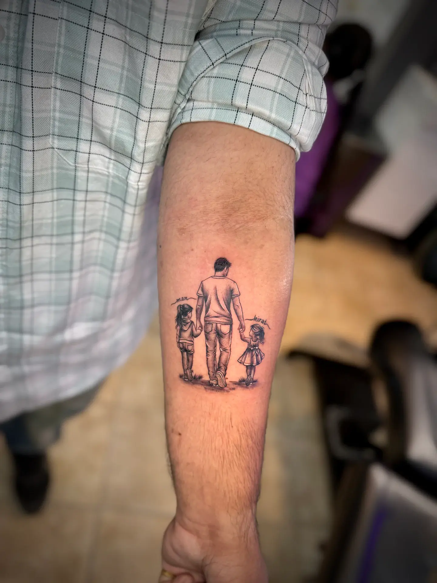 Black and grey micro-realism tattoo of father walking with two young daughters