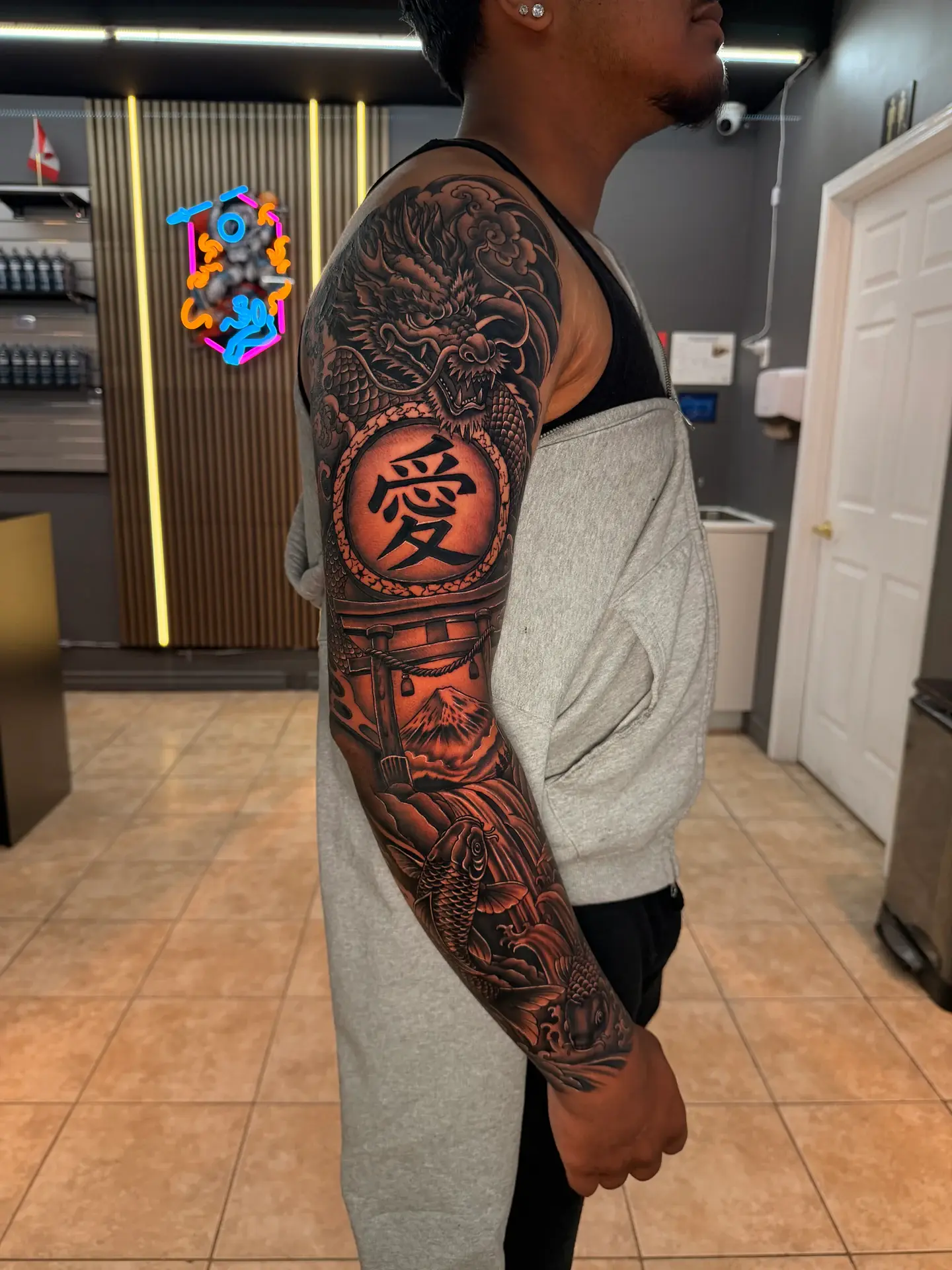 Black and grey full Japanese sleeve featuring dragon, Kanji emblem, Torii gate, and Koi