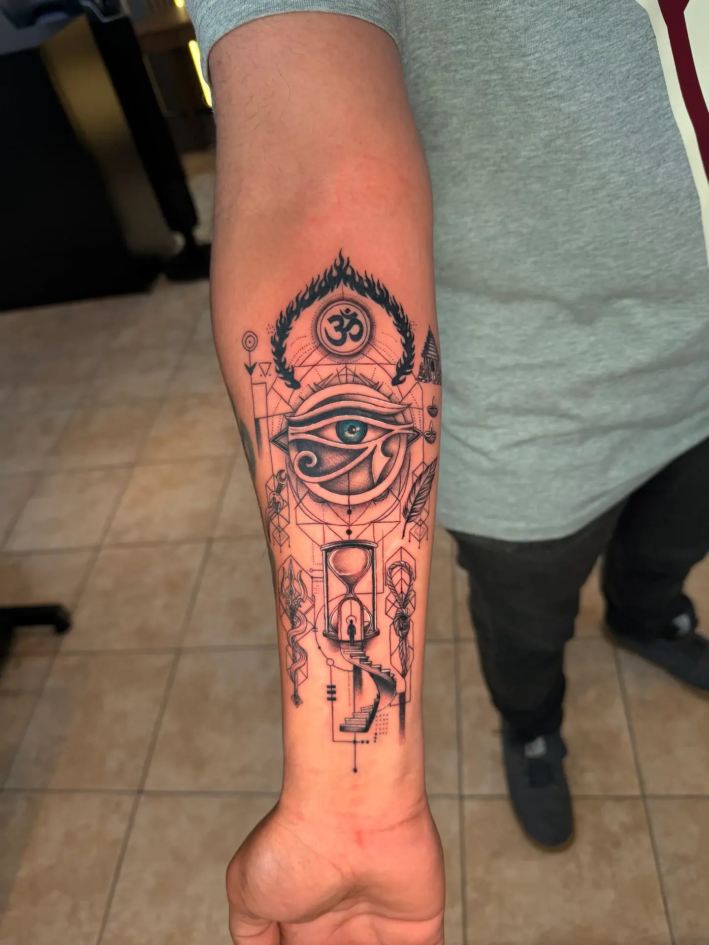 Black and grey sacred geometry sleeve with teal Eye of Horus and spiral staircase