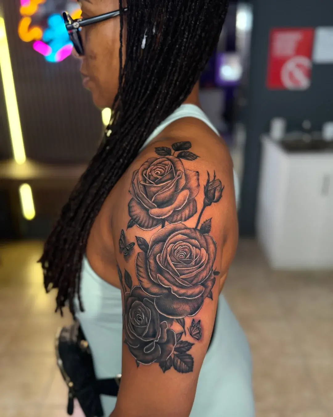Black and grey floral rose cover-up tattoo on shoulder