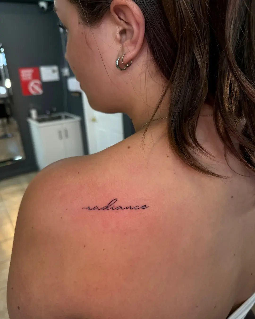 Fine line script reading radiance on the back shoulder